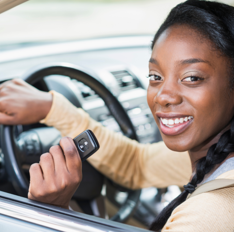 Woman in car holding key fob