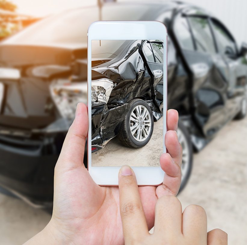 female hold mobile smartphone photographing car accident for insurance